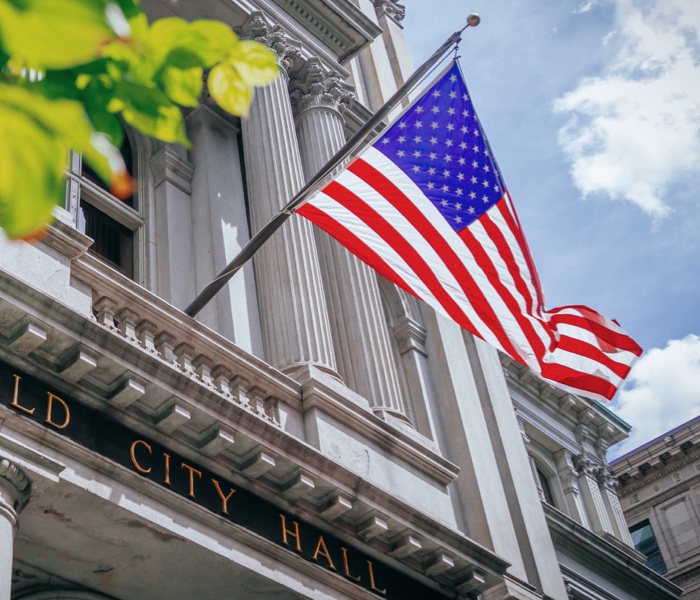 Flag on a city hall building representing the Municipal Services market