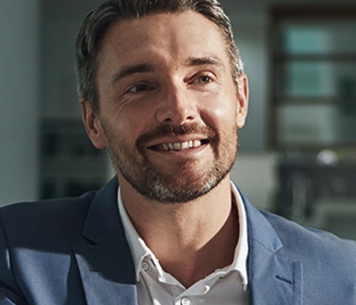 White man with well-trimmed beard, wearing a sport coat, representing people who work in Procurement roles